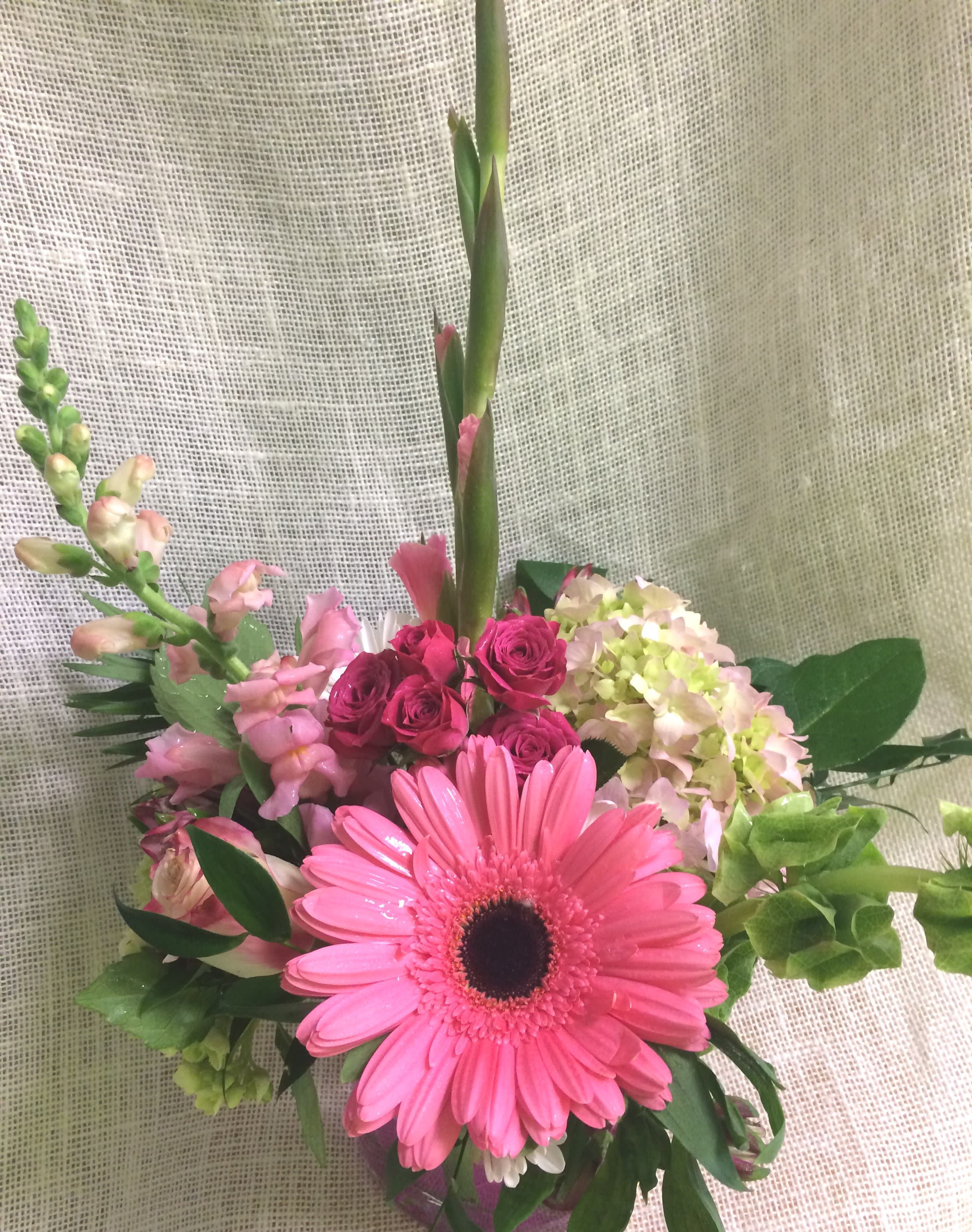 A little Pink me Up - Varied Pink Blossoms - One of our best loved arrangements, these soft and subtle shades of pink are perfect to say "Thank You," "Happy Birthday," "Get Well," or "I Love You". Gorgeous Seasonal Pinks may include Gerbera Daisies, Lilies, and Roses, accented by lovely greens and whites.   We custom create each piece based on availability and seasonality of flowers, and want each arrangement to be one of a kind.  Rest assured- your arrangement will have the look and feel you've chosen.  Please feel free to leave comments for the designer you would like us to take into account in designing your unique arrangement.