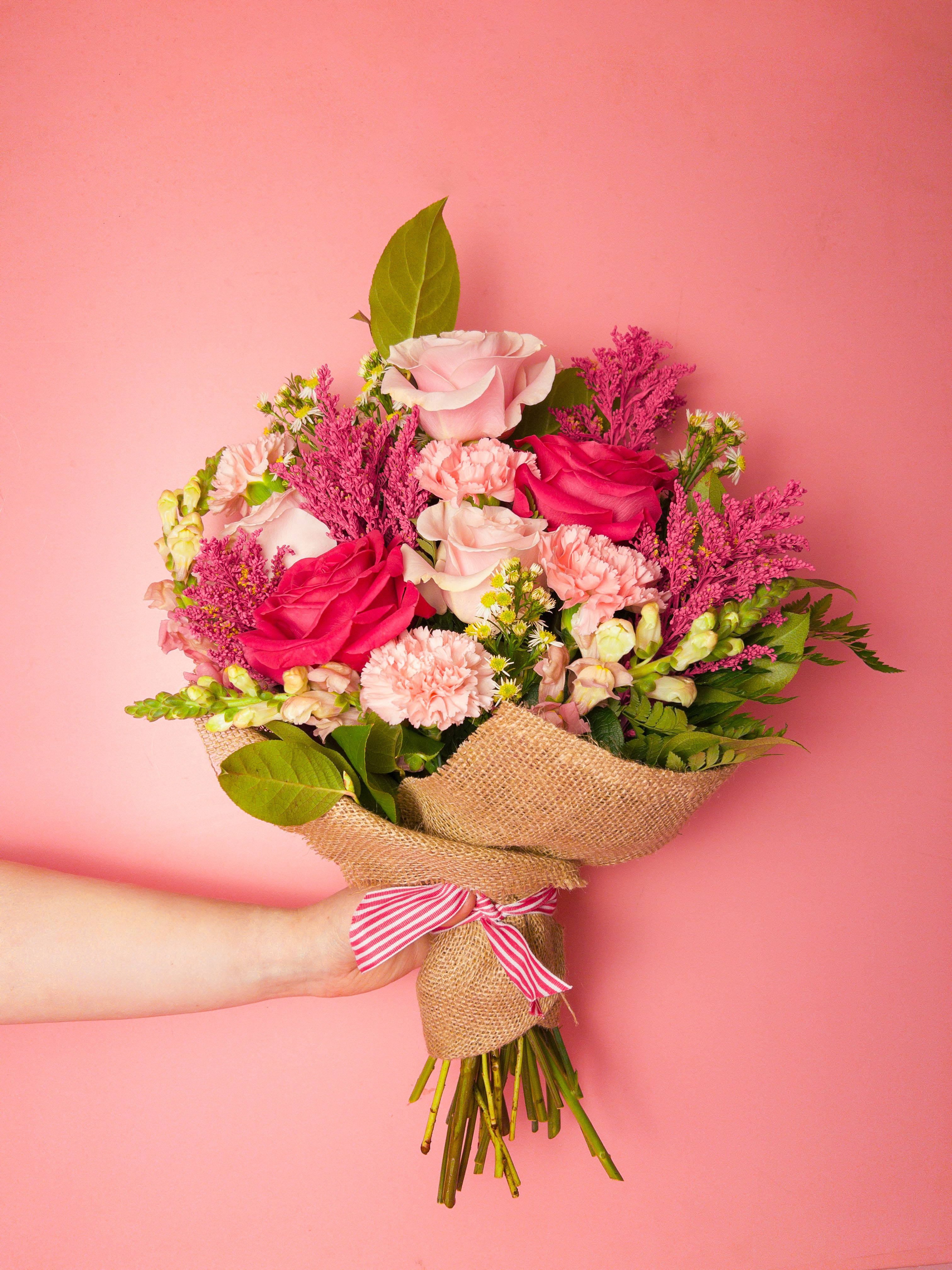 Blush Theory Bouquet - Pale and hot pink blooms mingle with each other in this hand-tied bouquet, creating a layered, textured look that reads cheerful and romantic. The Blush Theory Bouquet is suited for birthdays, spring celebrations, or simply to let someone know you're thinking of them - the color story is the message: soft pinks for tenderness and brighter pinks for joy. As a Florist offering local Flower Delivery in Baltimore, we craft each bouquet to make the recipient feel truly celebrated.  Wrapped and finished with a  ribbon, this bouquet combines soft, ruffled petals with spiky accents and tall leaves for contrast and height. While the exact varieties may vary with the seasons, the emphasis is on the pink palette to preserve the same romantic, springlike effect. Perfect for everyday gifting, anniversaries, or get well wishes - order with Flower Delivery in Baltimore for same-city delivery and give someone you care about a bouquet that feels thoughtful, bright, and beautifully personal.