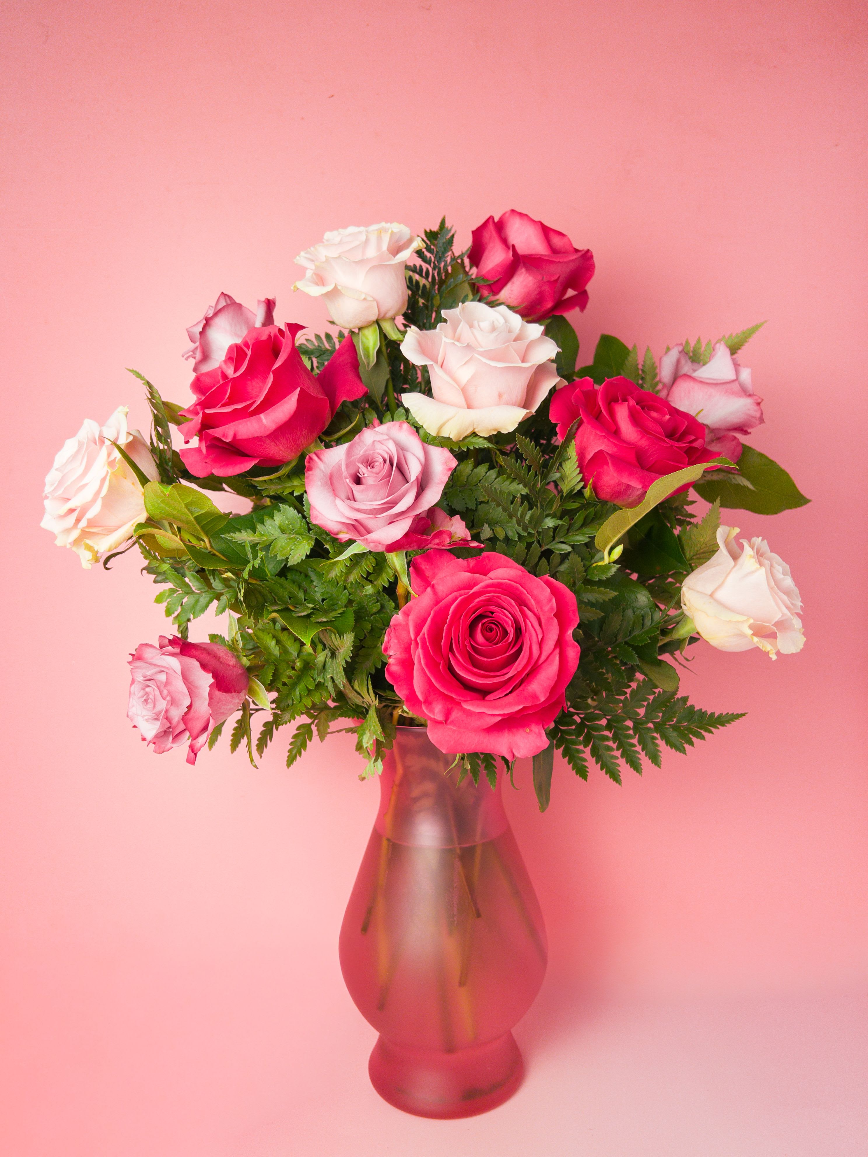 Rosé All Day Arrangement - A lush cluster of pink, hot pink, and blush blooms gathered tightly in a glass vase, this Rosé All Day arrangement reads like a celebration in soft, feminine color. Perfect as a birthday surprise, anniversary roses, or a "just because" pick-me-up, the vivid and creamy pinks give a warm, joyful impression that makes the recipient feel cherished and seen. As a Baltimore Florist offering reliable Flower Delivery in Baltimore, we craft this arrangement to make any gifting moment feel effortlessly elegant.  Made up of roses, the design is upright and full with greenery adding texture and movement. The glass vase keeps the presentation classic and gift-ready; sizing is standard florist arrangement dimensions for a tabletop centerpiece. This is an ideal choice when you want to express love, appreciation, or congratulations. Order from your local florist for same-day Flower Delivery in Baltimore and ensure your person receives a vibrant and surprise.