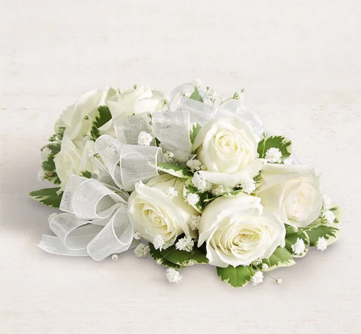 White rose bouquet with baby's breath and a sheer ribbon bow