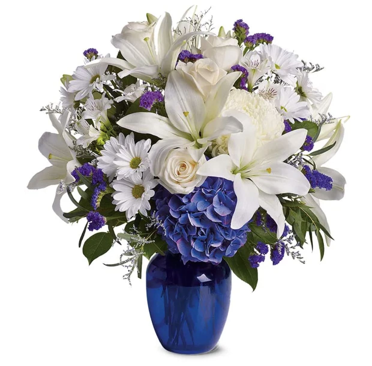 White lilies and daisies with purple accents in a blue vase