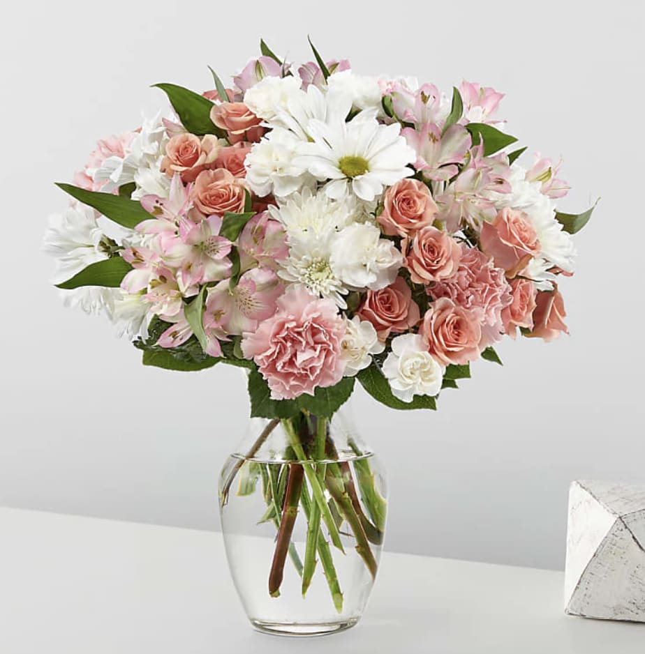 Pink and white mixed bouquet in a clear glass vase