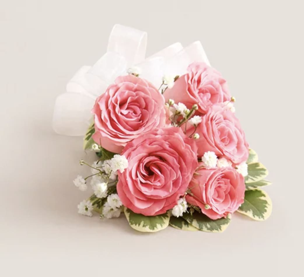 Pink rose bouquet with white filler flowers and a white ribbon bow
