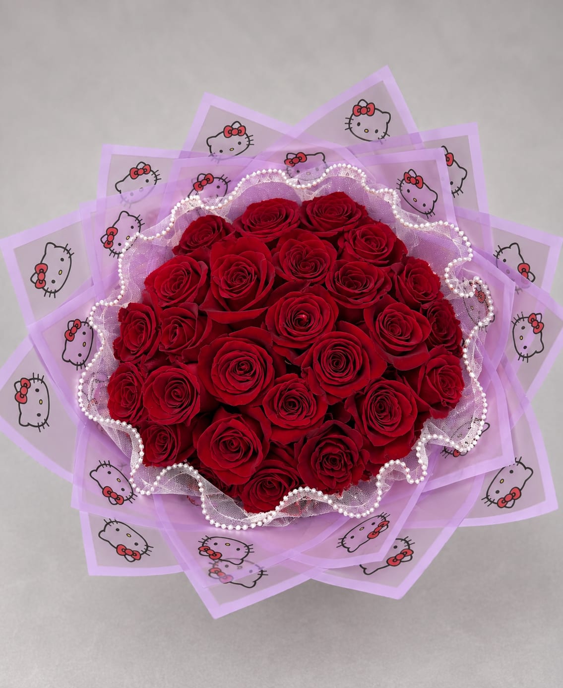 Bouquet of red roses wrapped in lavender Hello Kitty paper