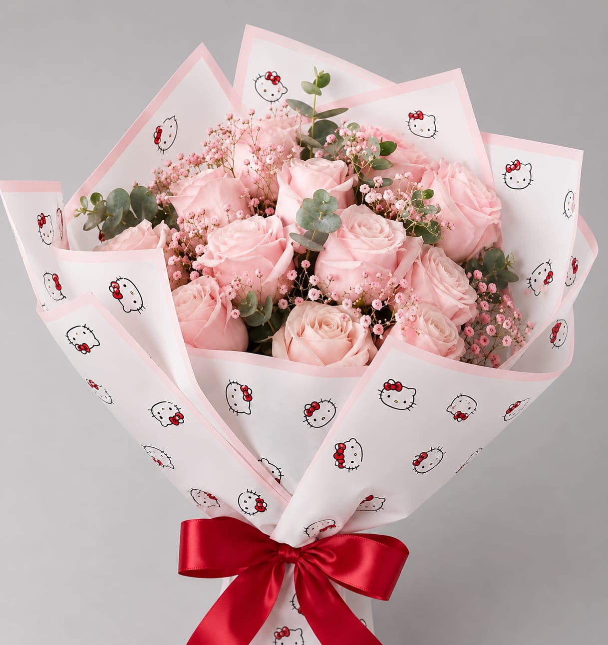 Pink rose bouquet wrapped in Hello Kitty paper with a red ribbon