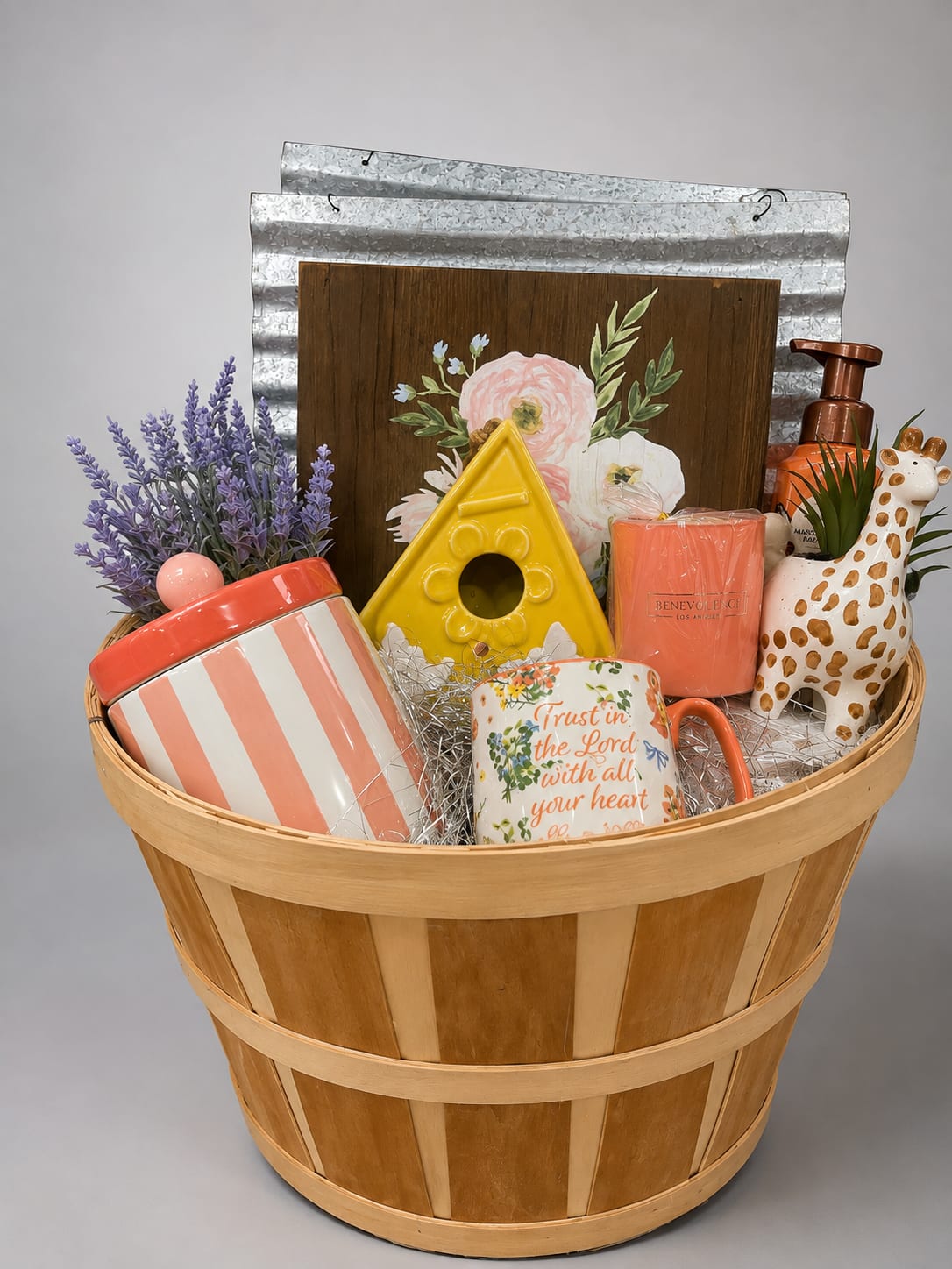 Gift basket with mugs, candle, soap, and a small faux plant