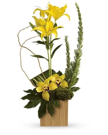 Yellow lilies and orchids in a wooden container