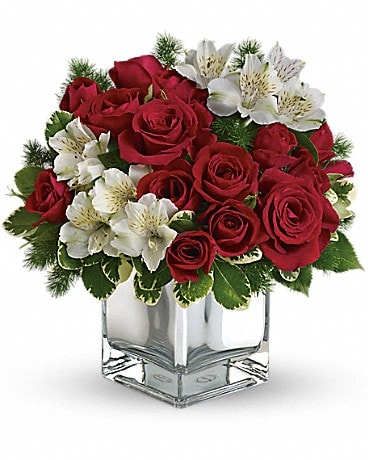 Teleflora's Christmas Blush Bouquet - Oh come all ye tasteful and send this stylish array of red roses and white alstroemeria in a chic mirrored silver cube. Beautiful and beautifully priced, it is a gift guaranteed to make spirits bright. The stylish Christmas flower arrangement includes red roses, red spray roses and white alstroemeria accented with pittosporum and ming fern.