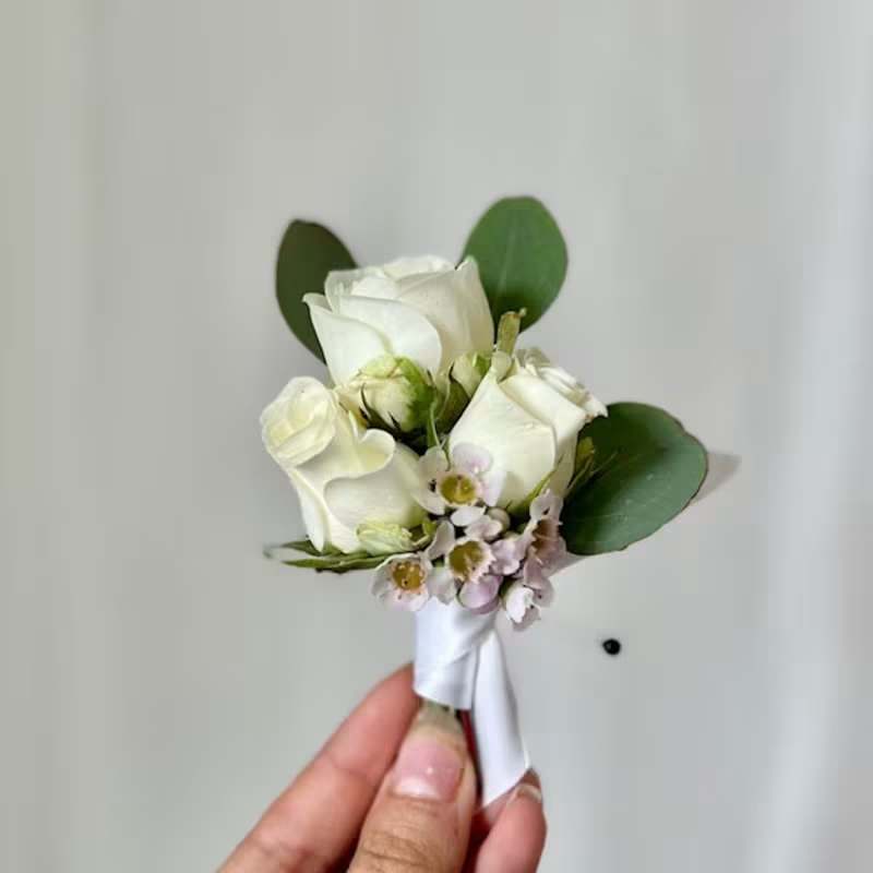Boutonnieres - Please state what color flowers and what color ribbon you'd like. We will use your request to the best of our ability, if you are looking for something specific, please call us at 919-493-1593 and we can help you from there.  