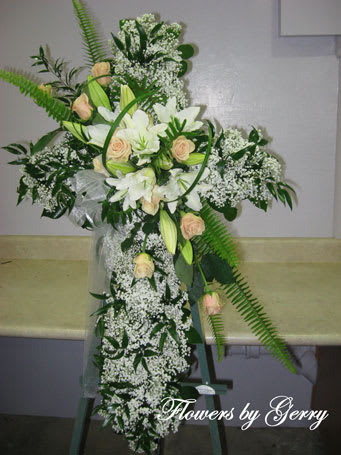 Tall white floral standing spray with peach roses and lilies