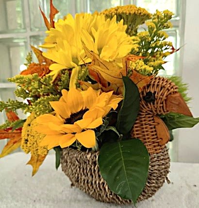 Gobble! Gobble! Centerpiece - This cute little woven rattan turkey contains a beautiful, fall colored centerpiece comprised of  Yellow, Orange and Purple flowers.   Fits perfectly on the center of a dining table, and end table, a coffee table or a kitchen counter.