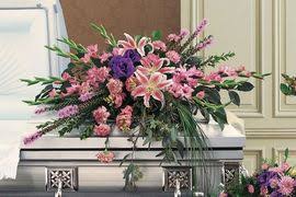 Large pink and purple floral casket spray with lilies and mixed blooms