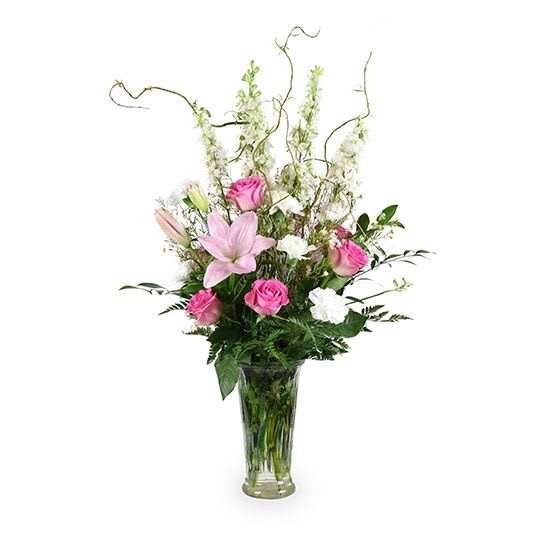 Pink roses and lilies in a clear glass vase