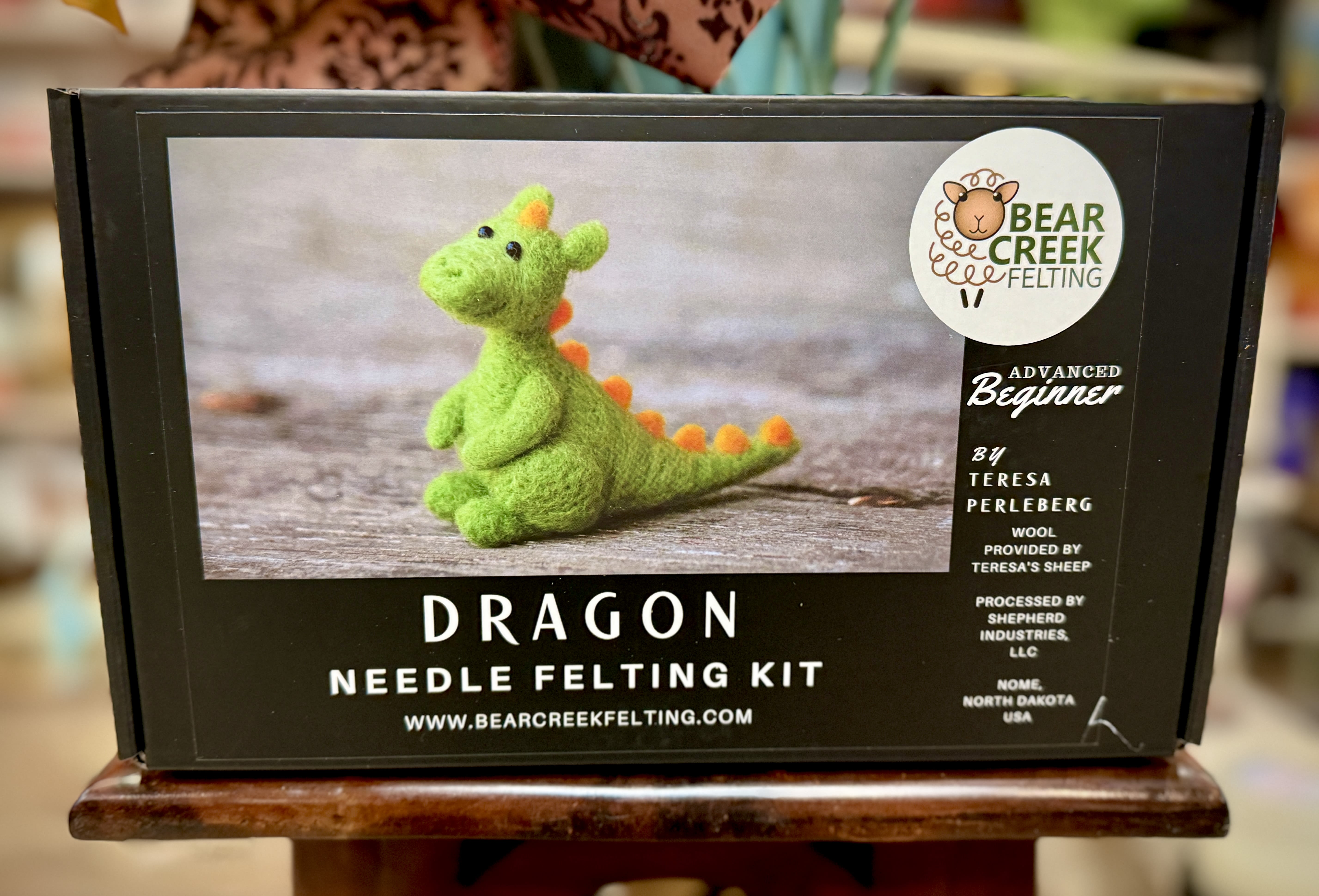 Boxed dragon needle felting kit with a green felt dragon on the front