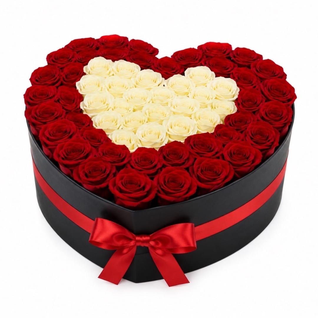 Heart-shaped box of red and white roses with a red ribbon bow