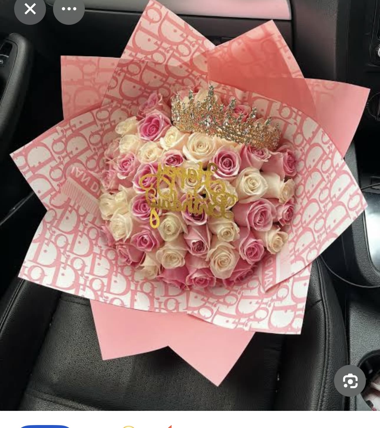 Pink and cream rose bouquet wrapped in patterned pink paper
