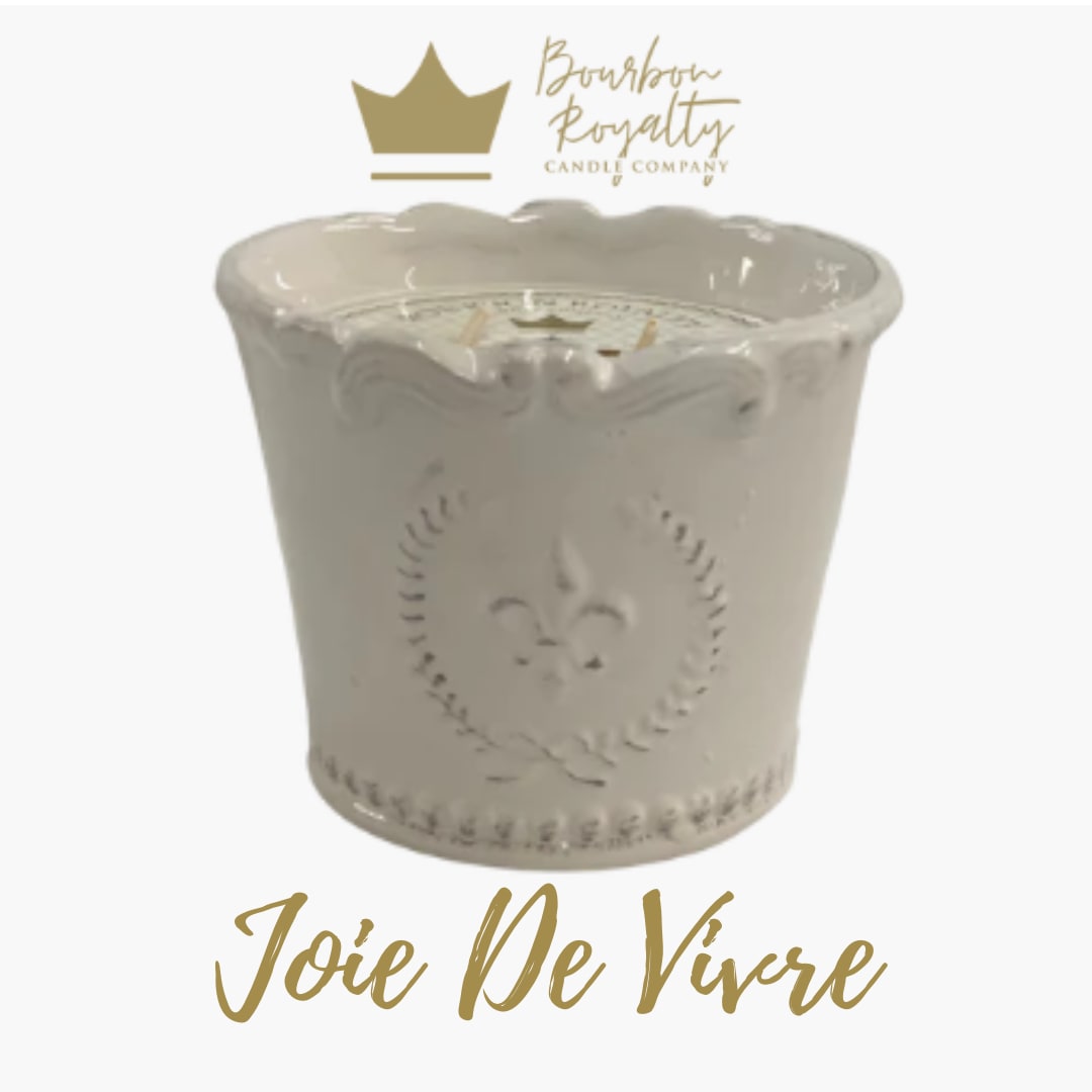White decorative candle jar with gold logo and text