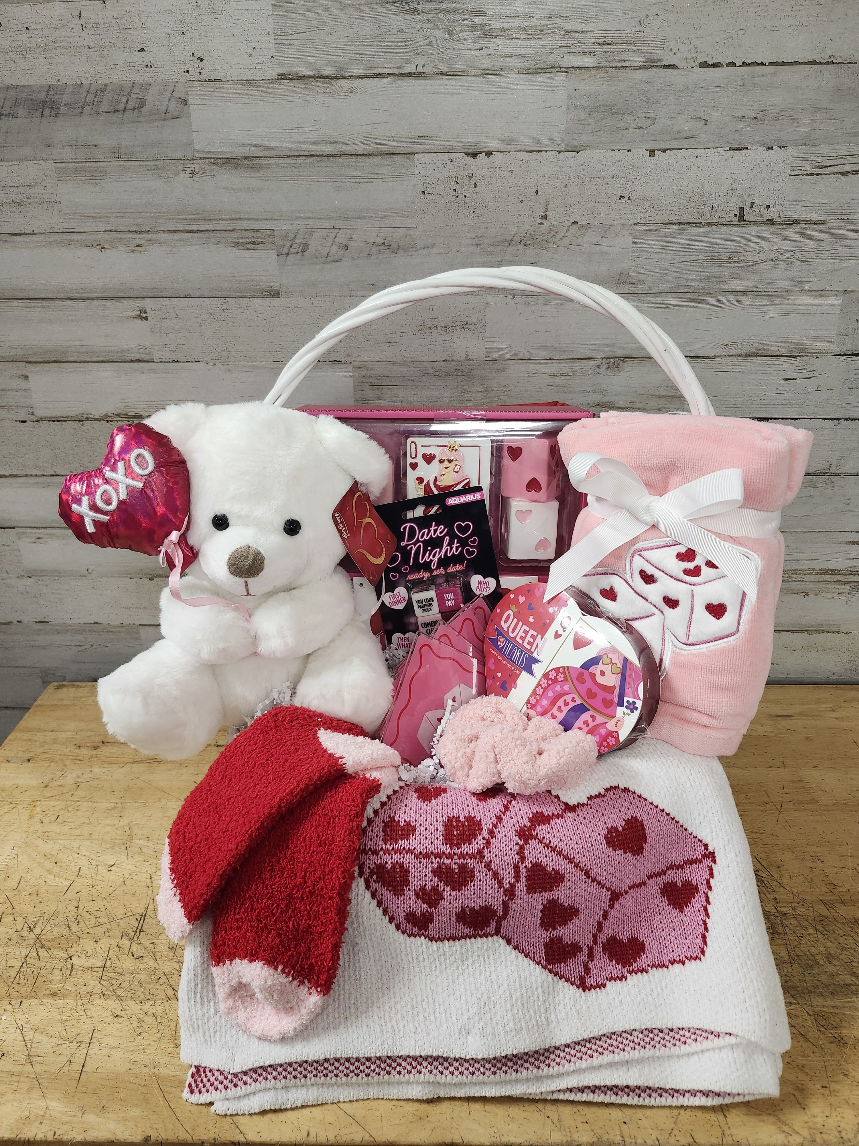 Dates &amp; Dice - $170 - Set the mood for date night with this cute &amp; cozy gift basket.   The basket contains: - Soft Knit Blanket - Cute Dice Decor - Plush Hand Towels - Set of 4 Acrylic Coasters - Date Night Dice - Roll to Determine the Activities - Cozy Socks - Sherpa Scrunchie - Chocolate - Please Note this will Differ - Teddy Bear - Delivered in Wicker Basket with Handle 