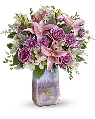 Stunning Swirls Bouquet - These gorgeous flowers make a stunning gift! This luxurious bouquet of roses and lilies looks perfect inside the swirling, iridescent beauty of this hand-blown art glass vase.