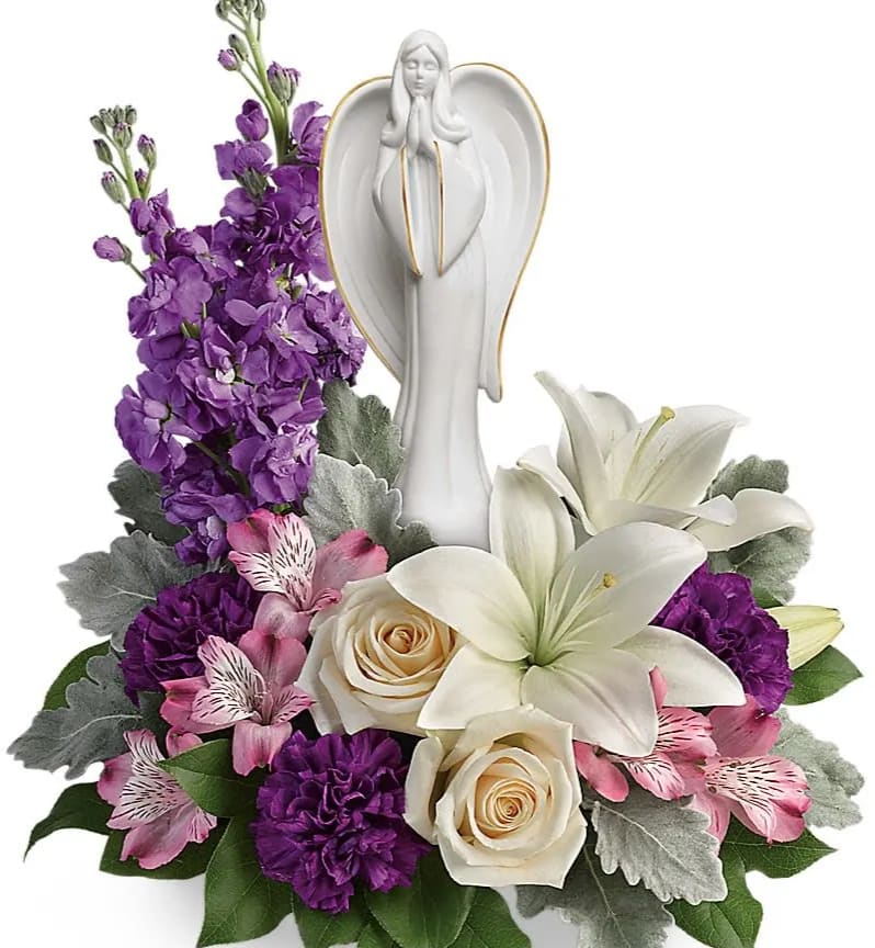 White angel figurine surrounded by purple and white flowers
