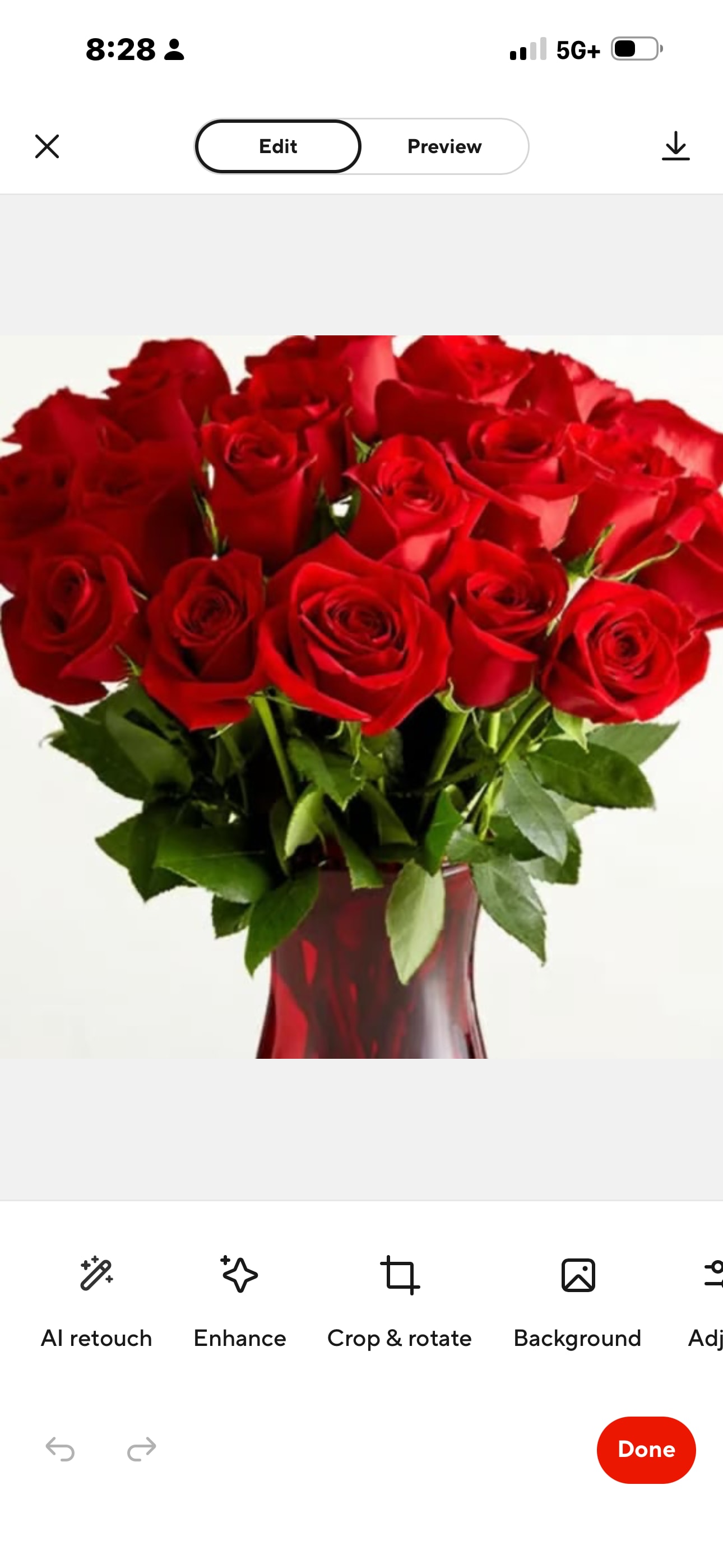 Bouquet of red roses in a red glass vase