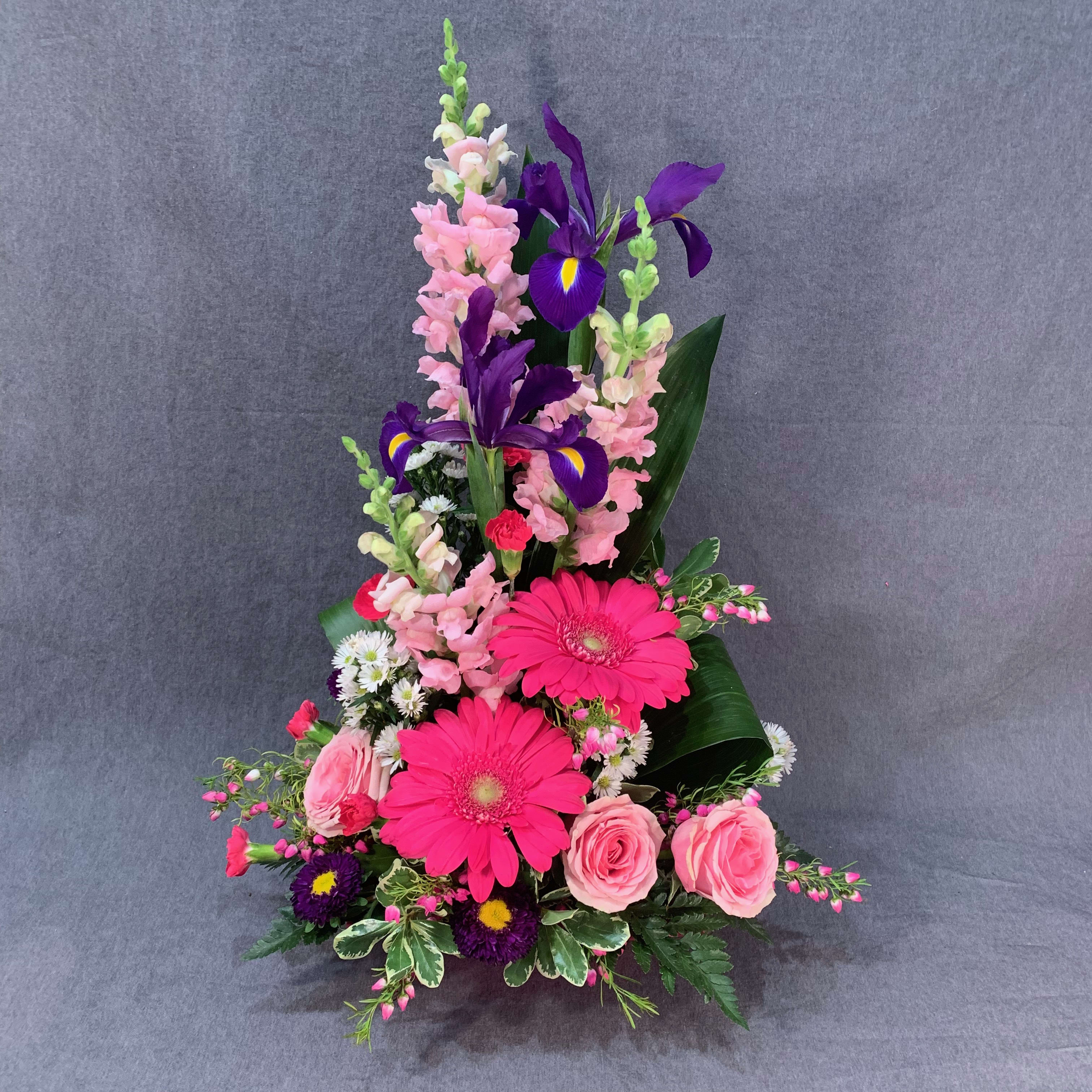 Tall bouquet with pink roses, hot pink gerberas, and purple irises