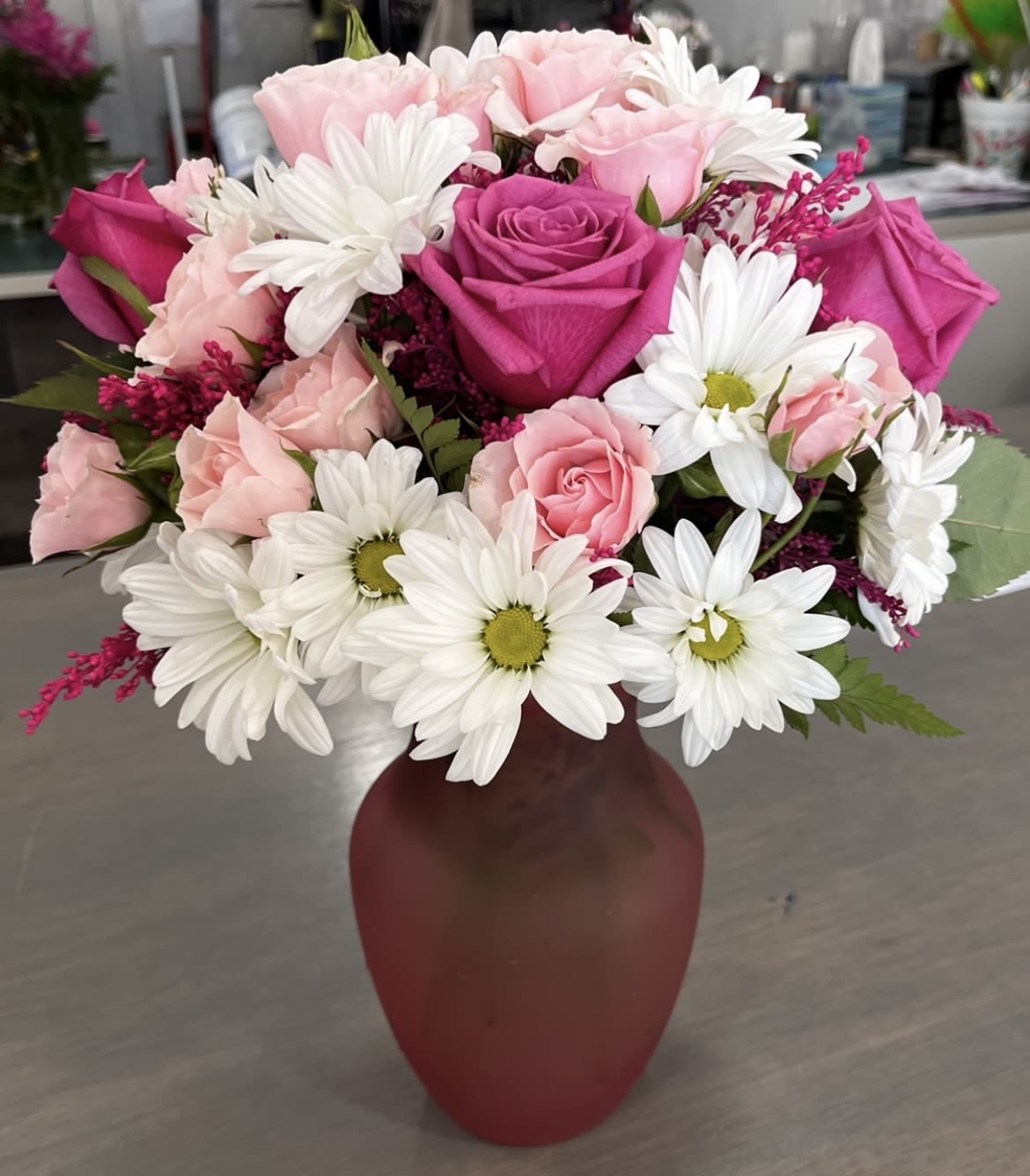Daisy Delight - This arrangement contains Roses, spray daisies and spray roses. 