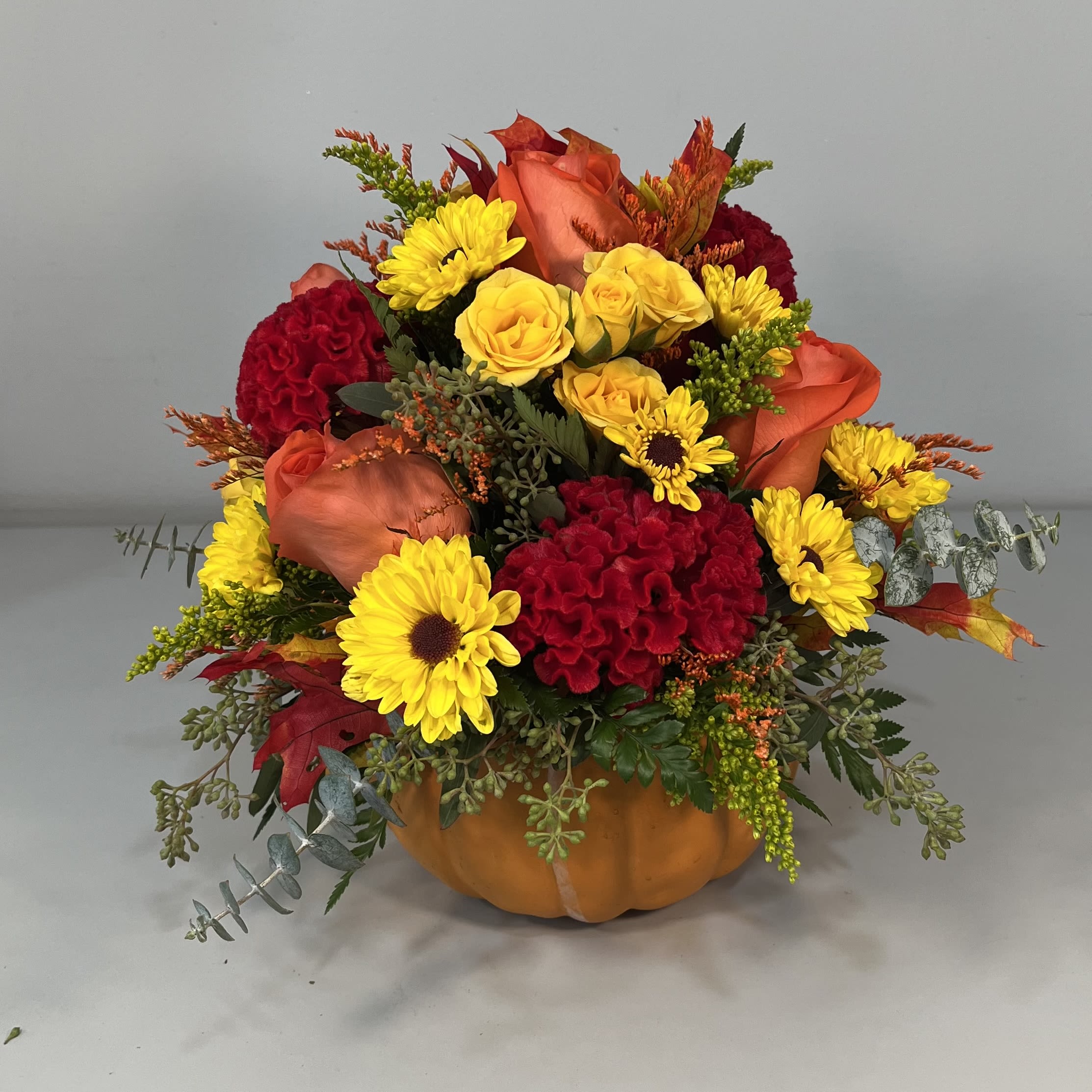 Pumpkin  -  Ceramic pumpkin filled with roses, viking daisies, spray roses and fall fillers (Flowers differ by availability)