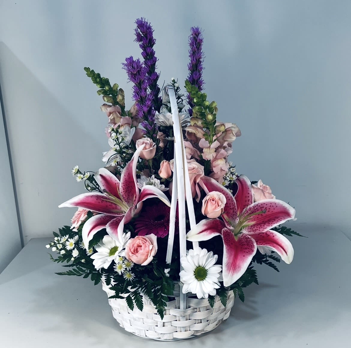 Stargazing Basket - White Basket with Stargazer Lilies, Liatris, Snap Dragons, Spray Roses And Daisies