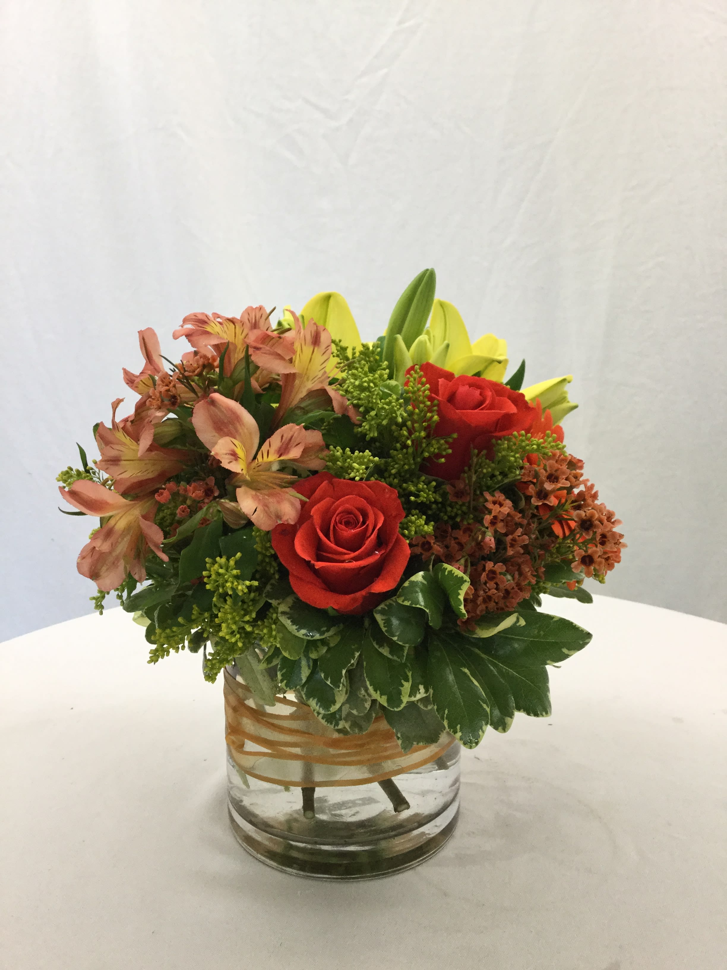 Autumn Elegance - This beautiful bouquet makes for a wonderful gift for the Autumn Season. Full of fresh blooms, hand-crafted and designed in a clear glass vase. Ribbon included.