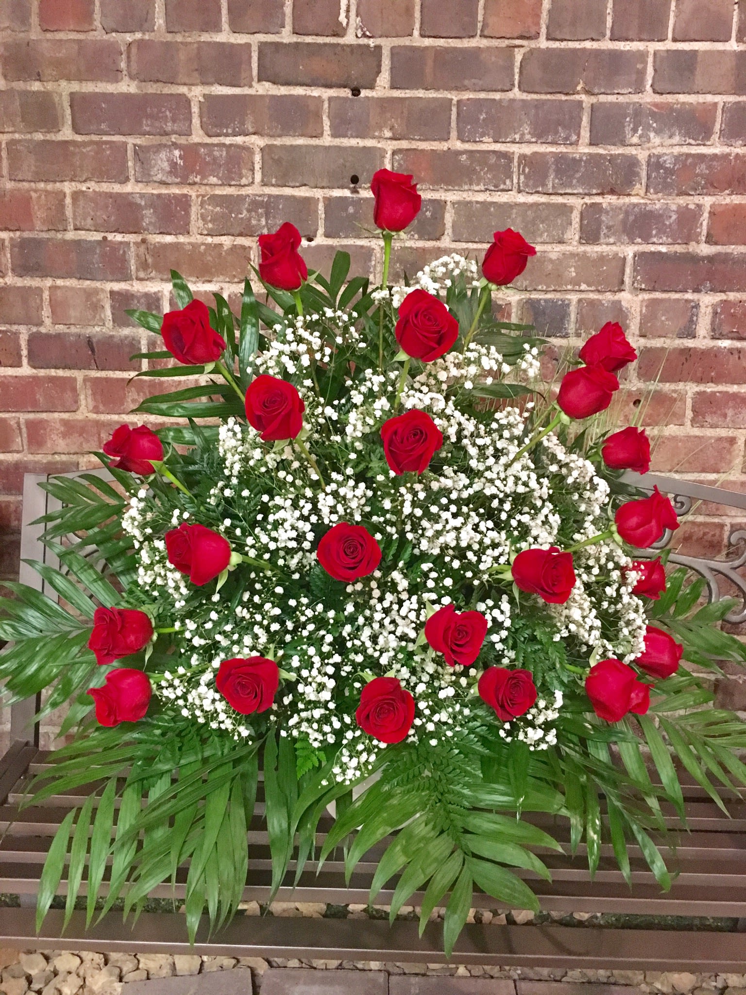 Large arrangement of red roses and white baby's breath