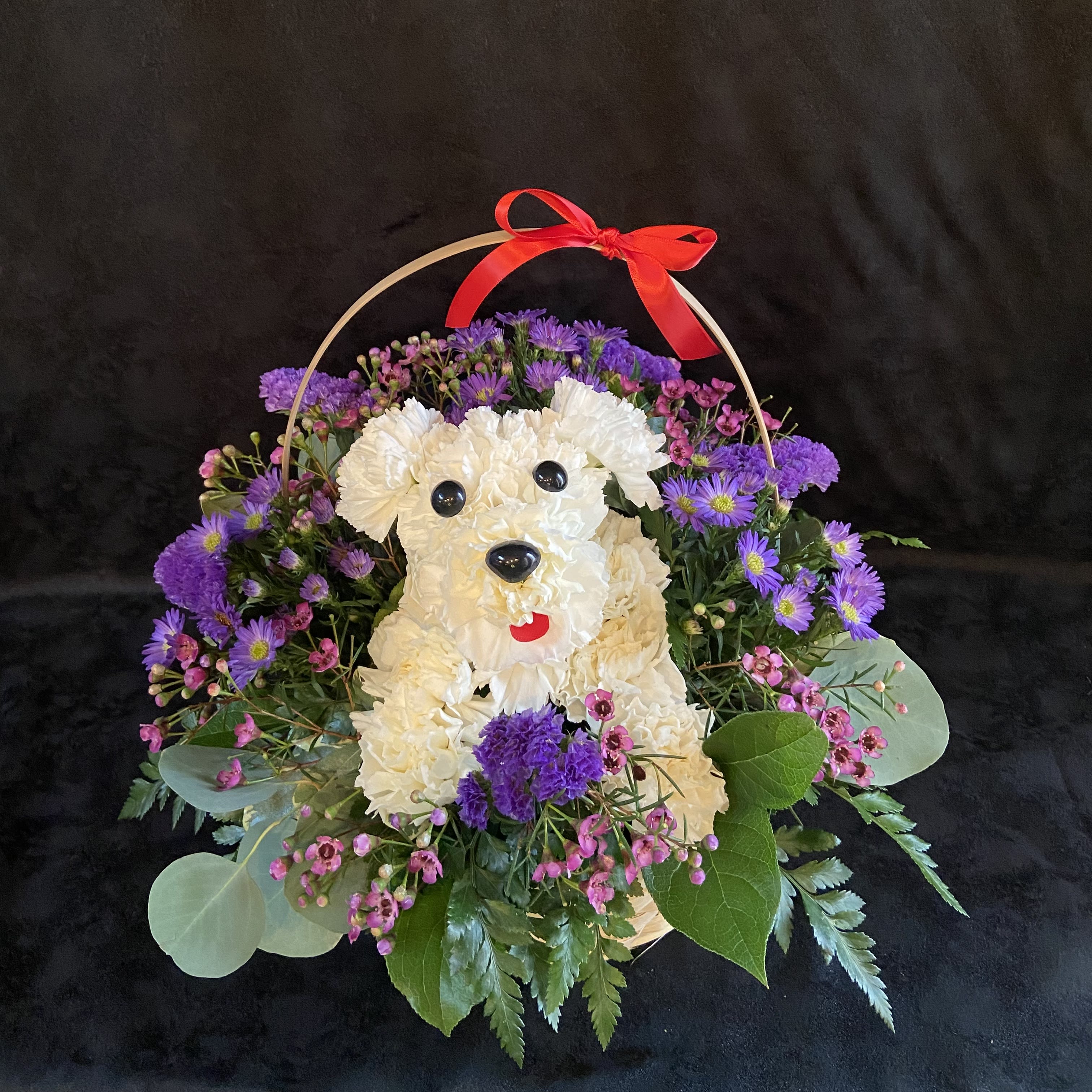 Flower basket shaped like a white dog with purple and pink blooms