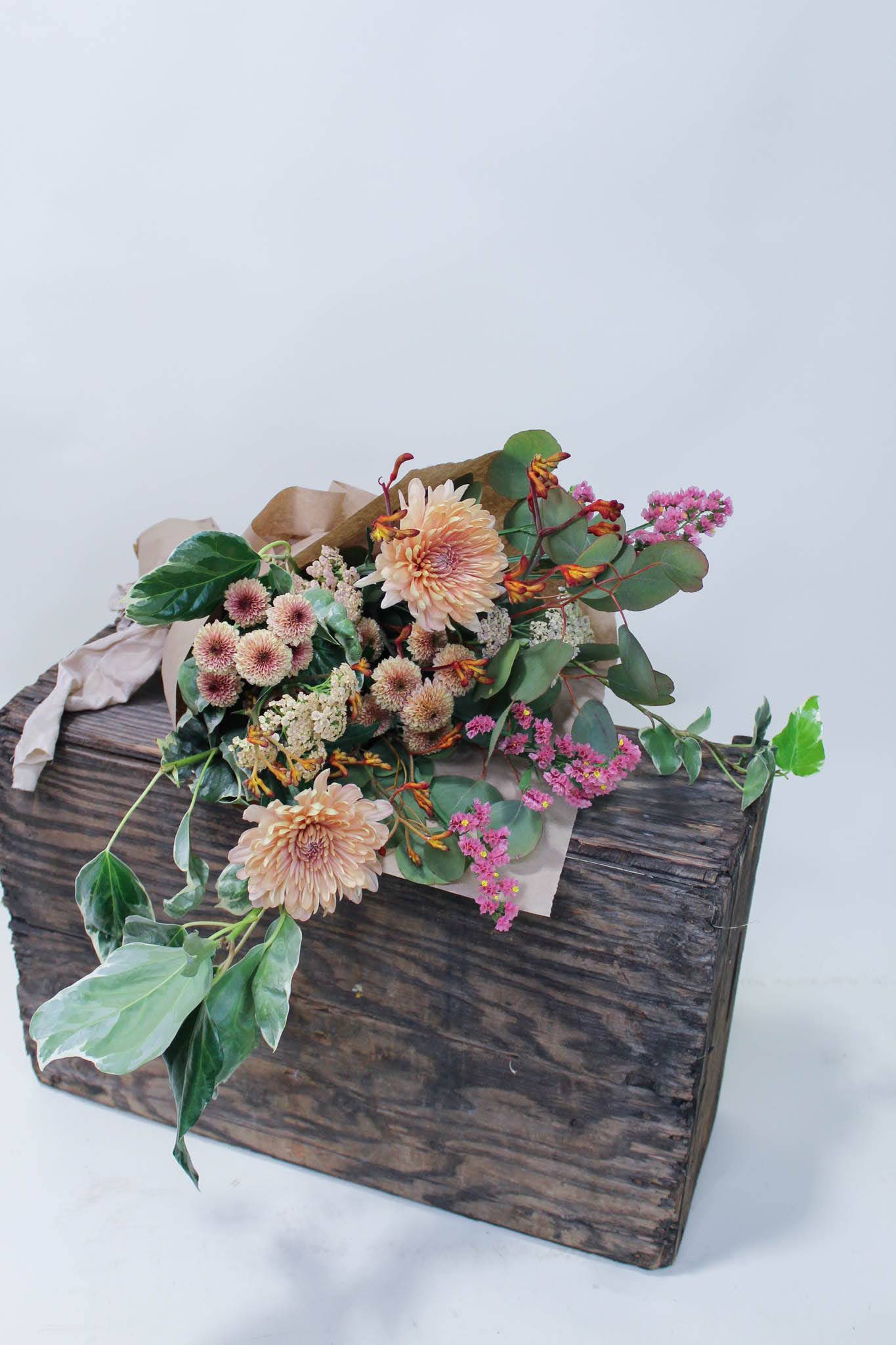 Mixed flower bouquet in a rustic wooden box