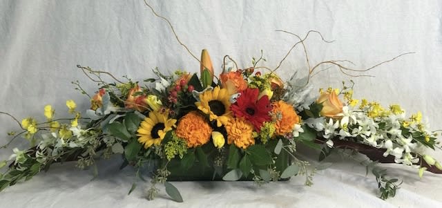 Turkey Trot - Full of Fall colored favorites in the warm colors of yellows, oranges, and reds. This is a perfect Thanksgiving arrangement.