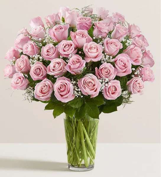 Pink roses arranged in a clear glass vase