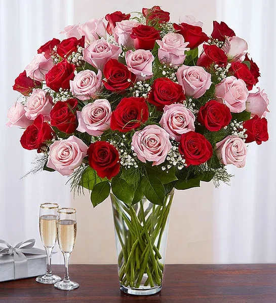 Bouquet of red and pink roses in a clear glass vase