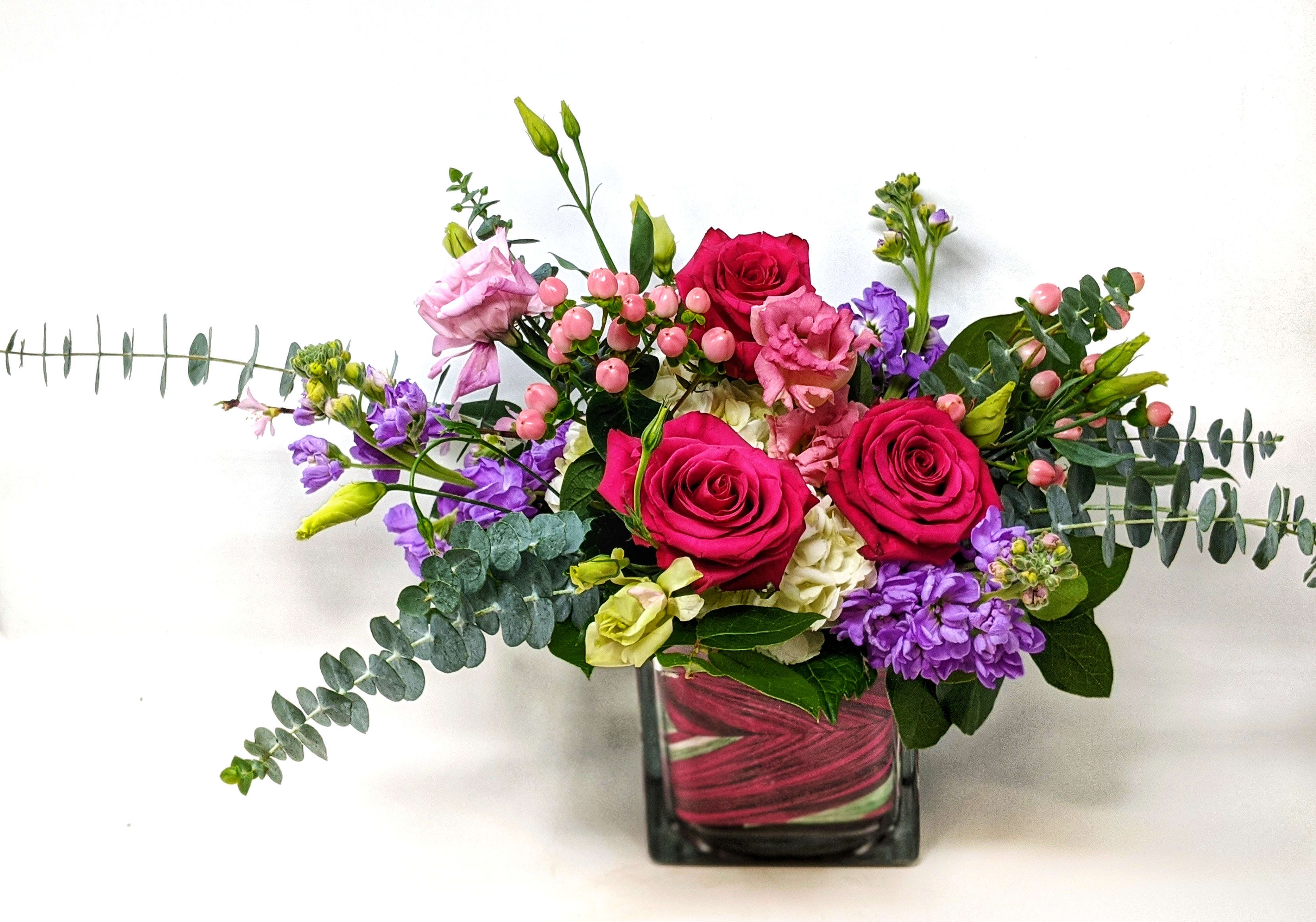 Sweet Love Cube - Lovely pink and lavender blooms artistically arranged in a glass cube. 