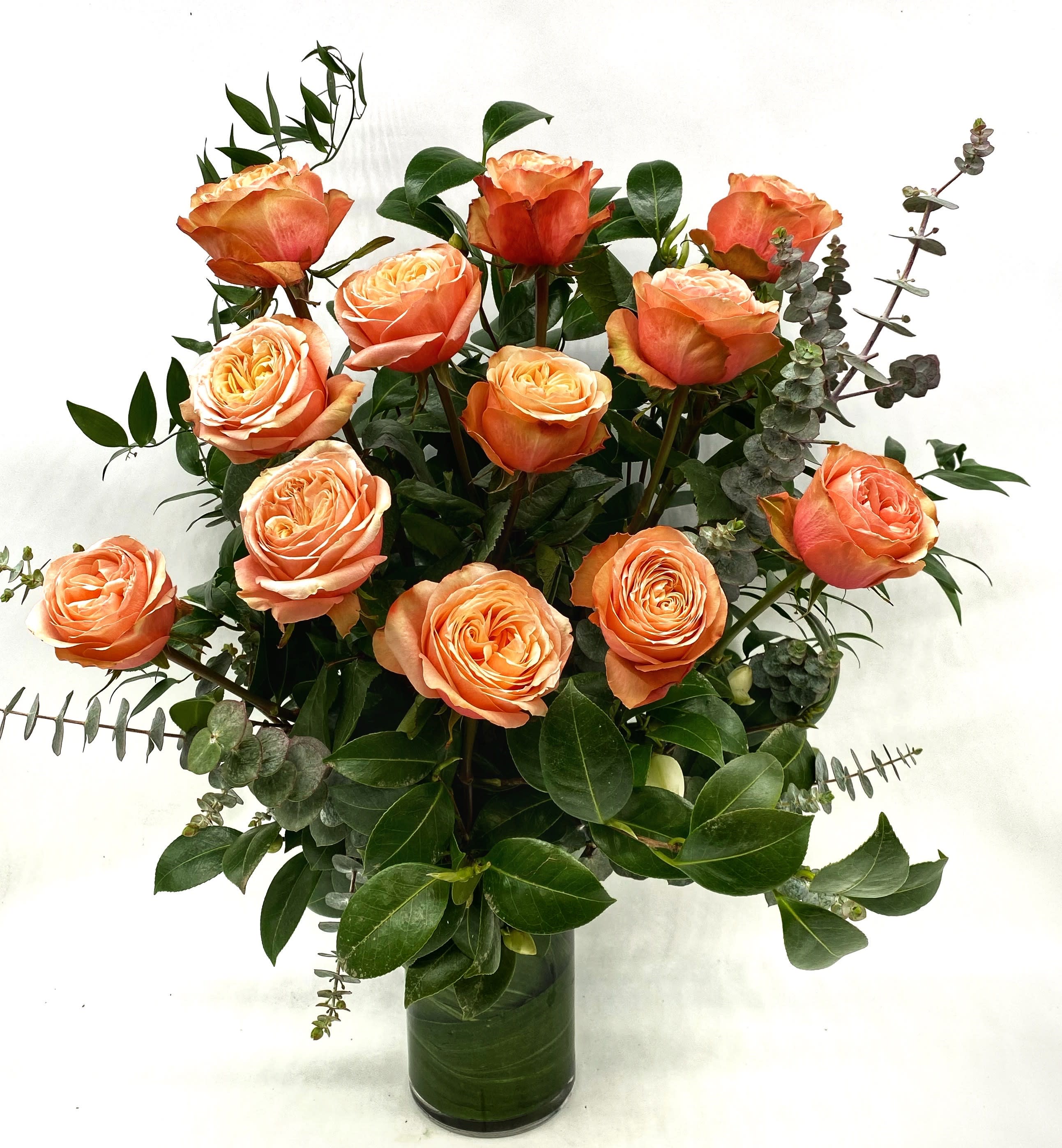 Peach Roses  - Our take on a classic arrangement of beautiful premium Peach Roses. Our roses are of the best quality in the industry and hand picked each week for the freshest blooms available. Choose between 1 dozen or 2 dozen roses arranged with seasonal greenery. A timeless gift of love or thoughtfulness. 