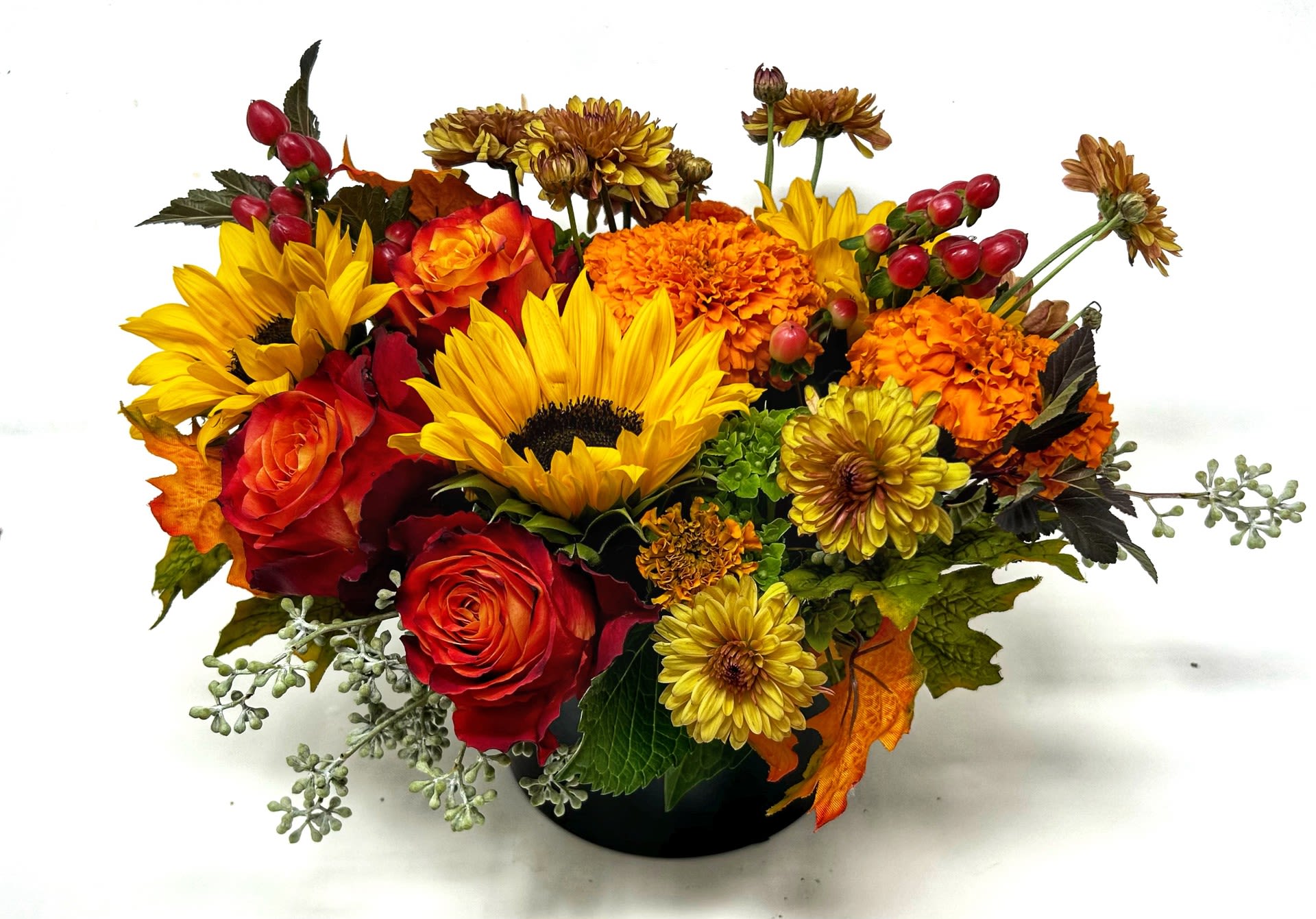 Bright Abundance  - Low and lush blooms in fall tones accented with bright green and silk leaf accents. Perfect as a small centerpiece or for a coffee table. 
