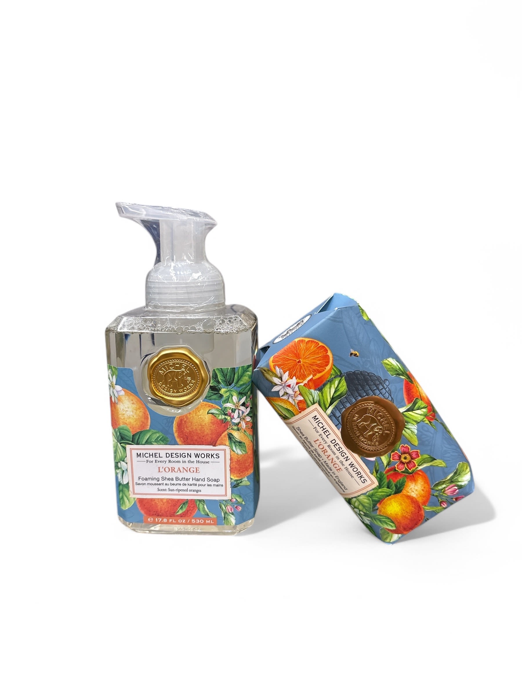 L'Orange Soap Set  - Foaming soap pump and large bar soap. Lush citrus groves burst with vibrant hues as ripe fruit hangs, ready for picking. Triple milled to distribute fragrance evenly, this luxurious orange bar soap is accented by warm undertones of vanilla and musk. Crafted with premium ingredients for a silky-smooth finish, our large shea butter soap bar is sized for repeat enjoyment while moisturizing your skin with every use. Made in England