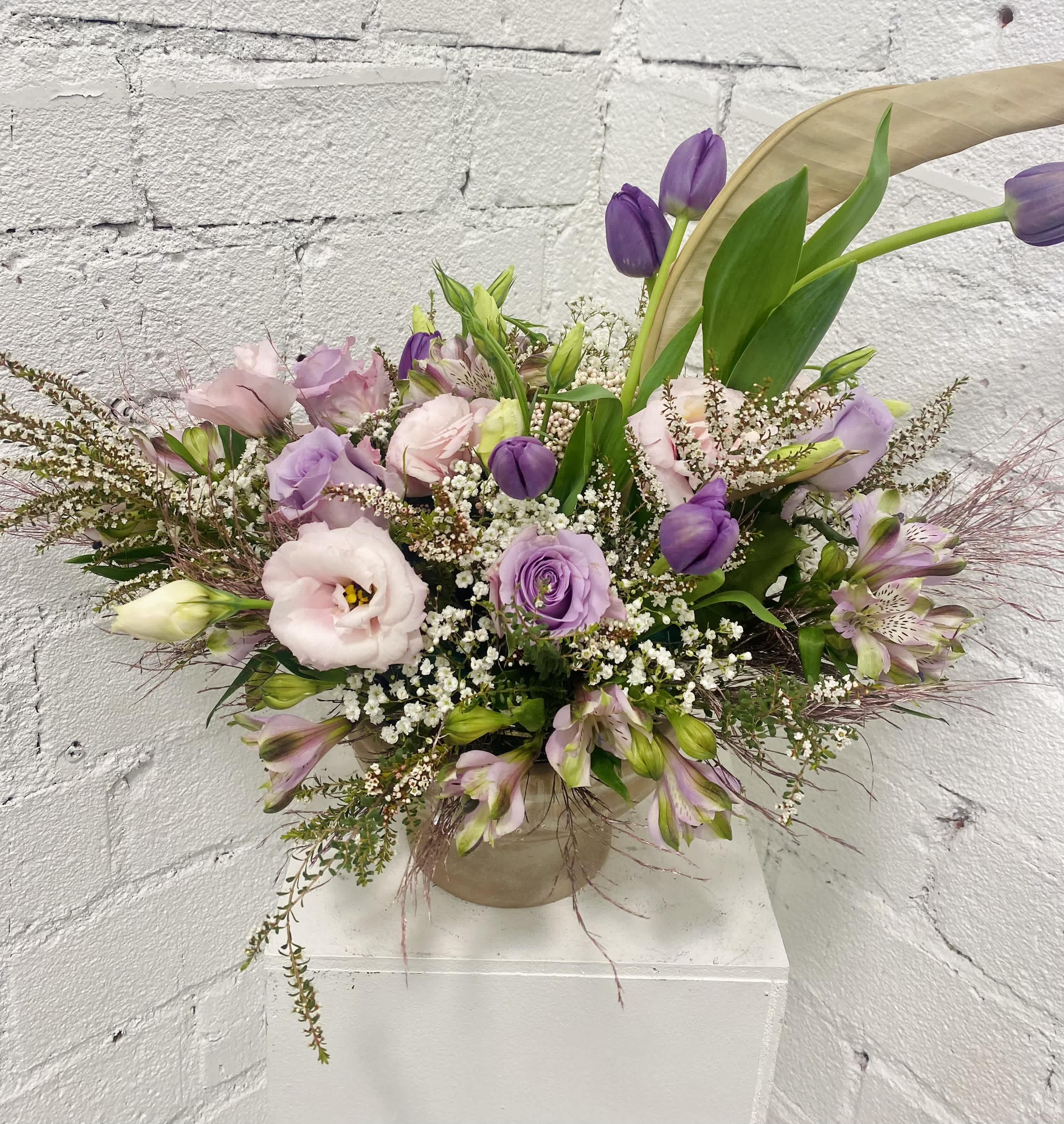 Lavender and pink bouquet in a beige vase