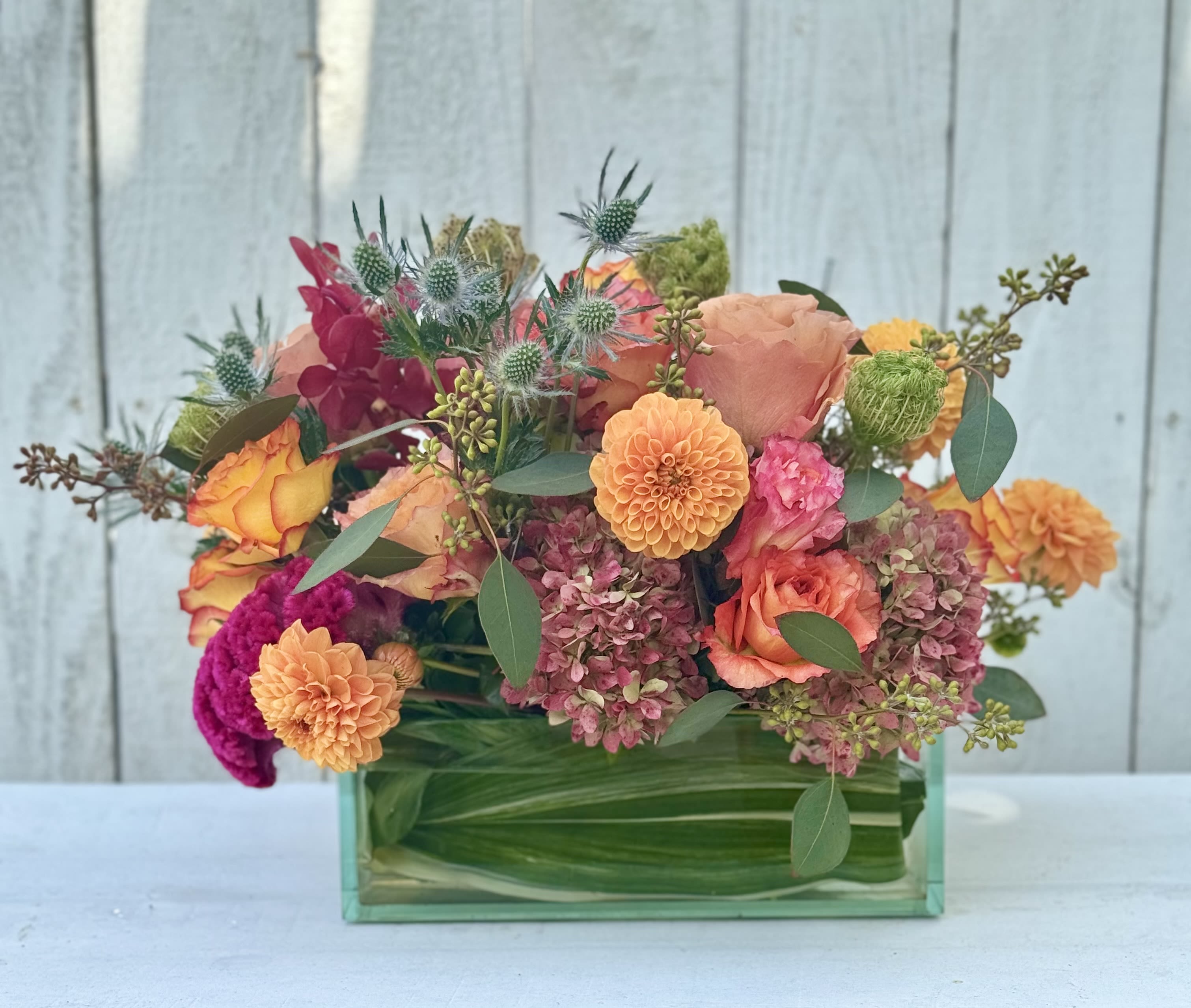 Colorful mixed bouquet in a rectangular glass vase