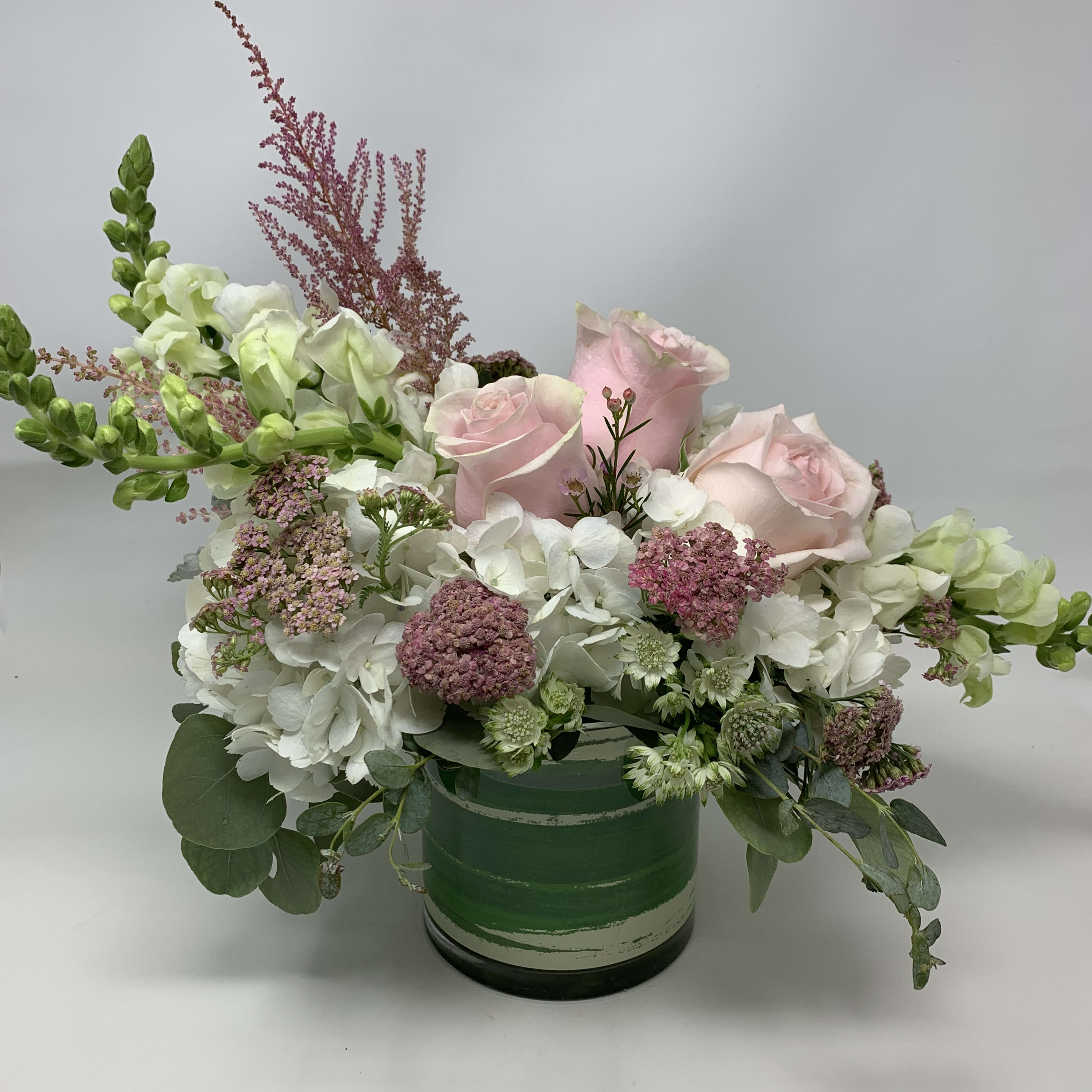 Sweet Pink  - Pink roses with white hydrangeas, snapdragons, fillers and greens arranged in a glass vase.