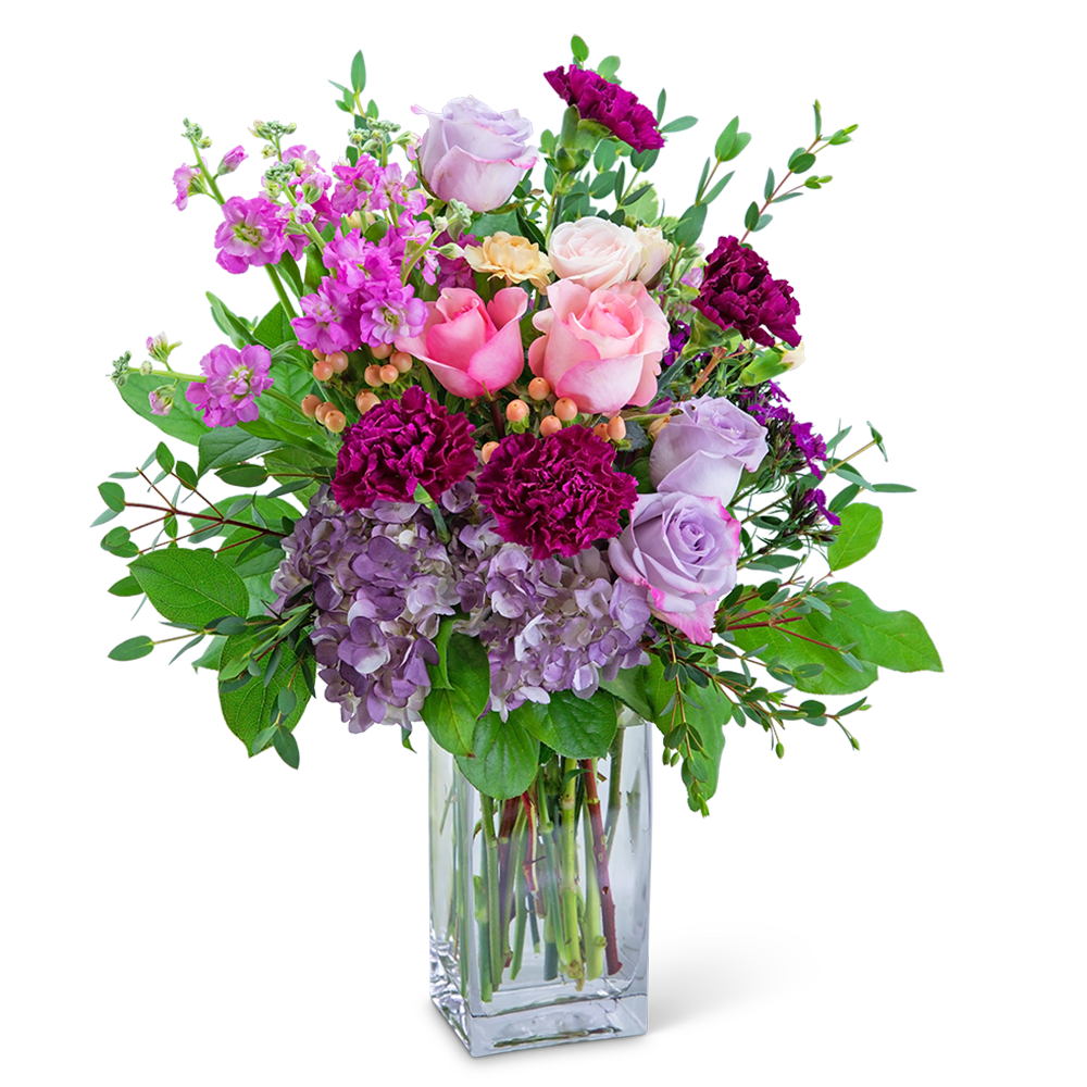 Pink and lavender roses with purple carnations in a clear glass vase