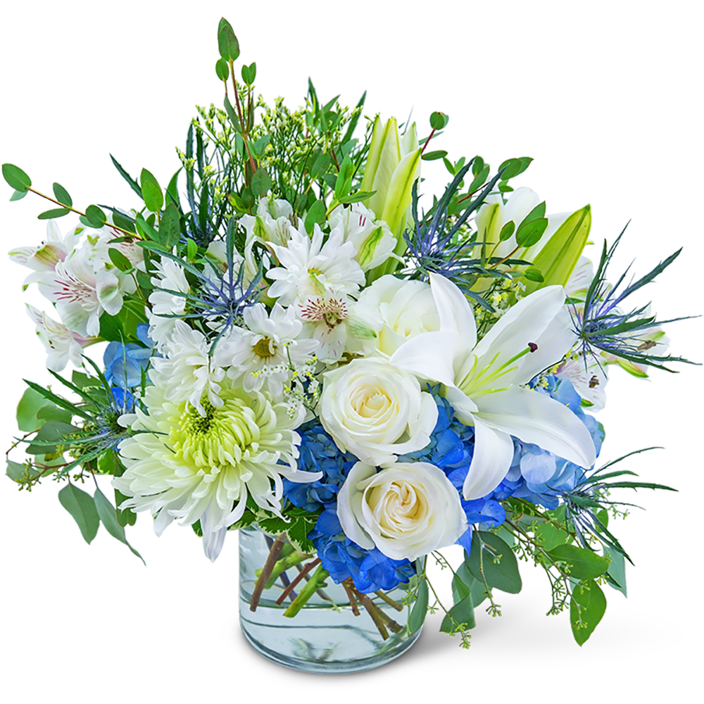 White lilies and roses with blue hydrangeas in a glass vase