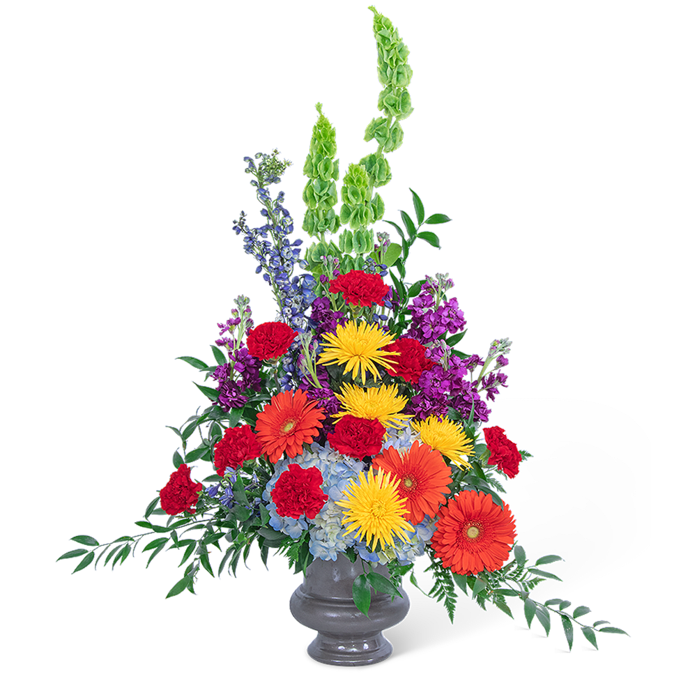 Tall mixed flower arrangement in a gray vase with bright red, orange, yellow, purple, and blue blooms