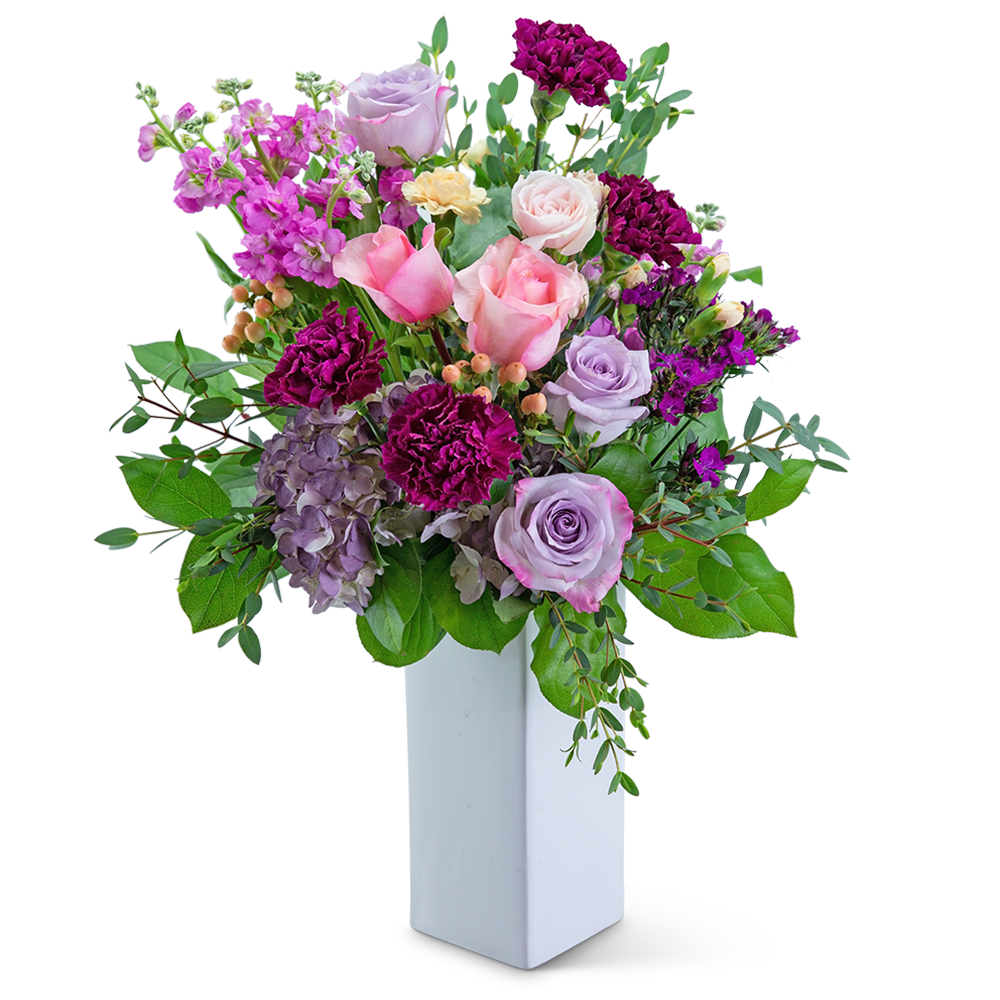 Mixed pink and lavender bouquet in a white vase