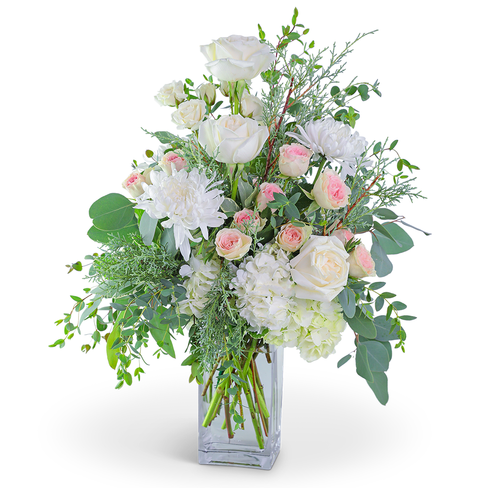 White roses and pink spray roses in a clear glass vase