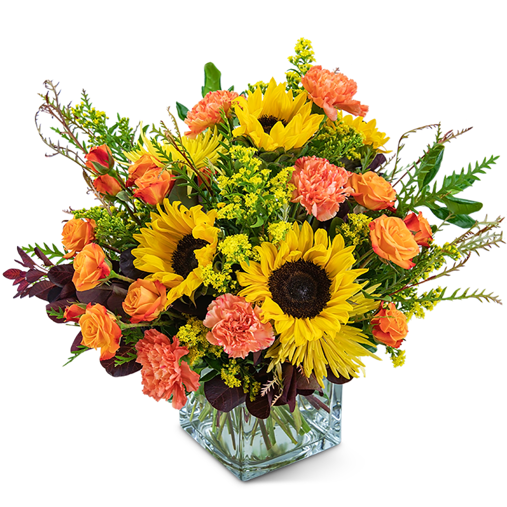 Sunflower and orange carnation bouquet in a clear glass vase