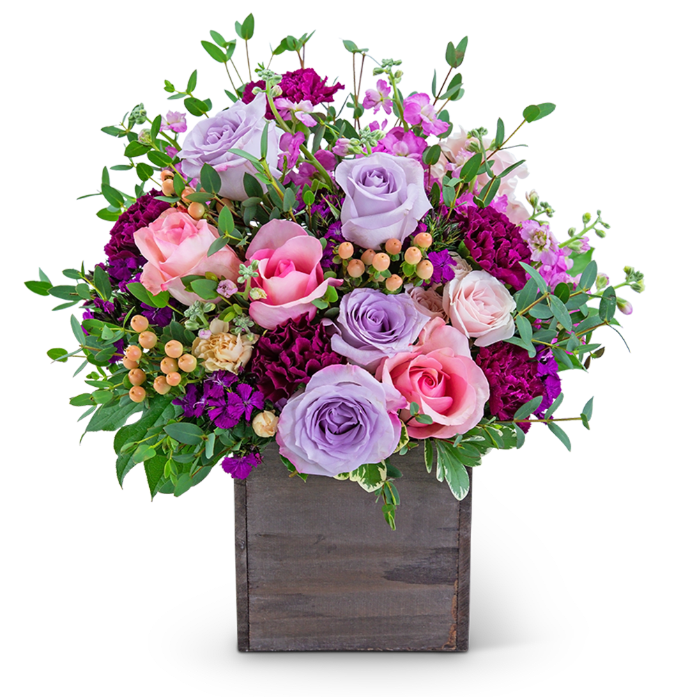 Lavender and pink roses in a wooden box with greenery